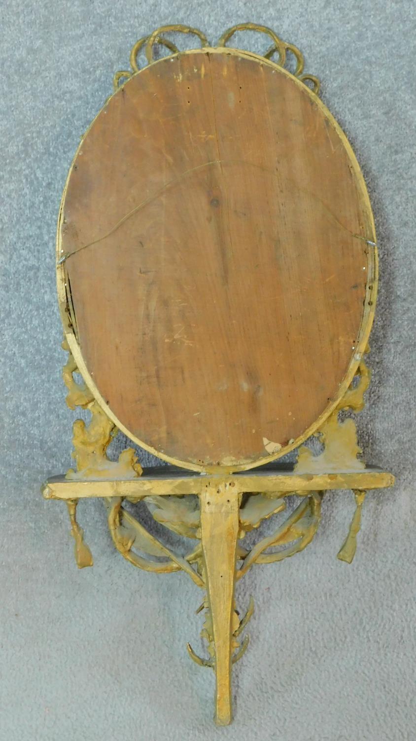 A late 19th century gesso framed wall mirror with shaped shelf and ribbon and swag decoration. - Image 5 of 5