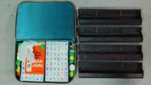 A vintage green and white plastic hand carved tricolour Mahjong set in leather effect zip up case.
