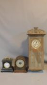 A collection of three antique clocks. One ebonised with a gilt metal handle and gilt engraved