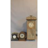 A collection of three antique clocks. One ebonised with a gilt metal handle and gilt engraved