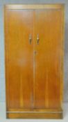 A mid 20th century oak Art Deco wardrobe fitted with drawers and shelves. H.178 W.91 D.43cm