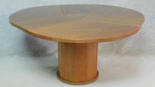 A contemporary Skovby, Denmark teak dining table fitted with sliding patent action integral