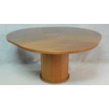 A contemporary Skovby, Denmark teak dining table fitted with sliding patent action integral