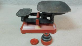 A set of C.W. Brecknell Ltd of Birmingham vintage red painted iron weighing scales with weights.