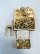 A collection of antique brass small clock parts including cogs, clock mechanisms, springs and a