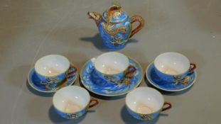 A hand painted vintage Japanese Lithophane tea set. The five cups have pictures of Geishas when held