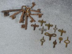 A collection of antique iron keys and various brass watch and clock keys. Largest 16.5cm.