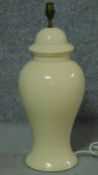 An Oriental style ceramic pale yellow glazed table lamp in the form of a lidded jar. H.58cm