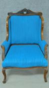 A late 19th century carved mahogany armchair in vibrant blue fabric painted upholstery on cabriole