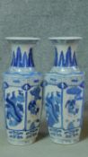 A pair of contemporary blue and white Oriental vases with foliate and floral design with panels