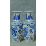 A pair of contemporary blue and white Oriental vases with foliate and floral design with panels