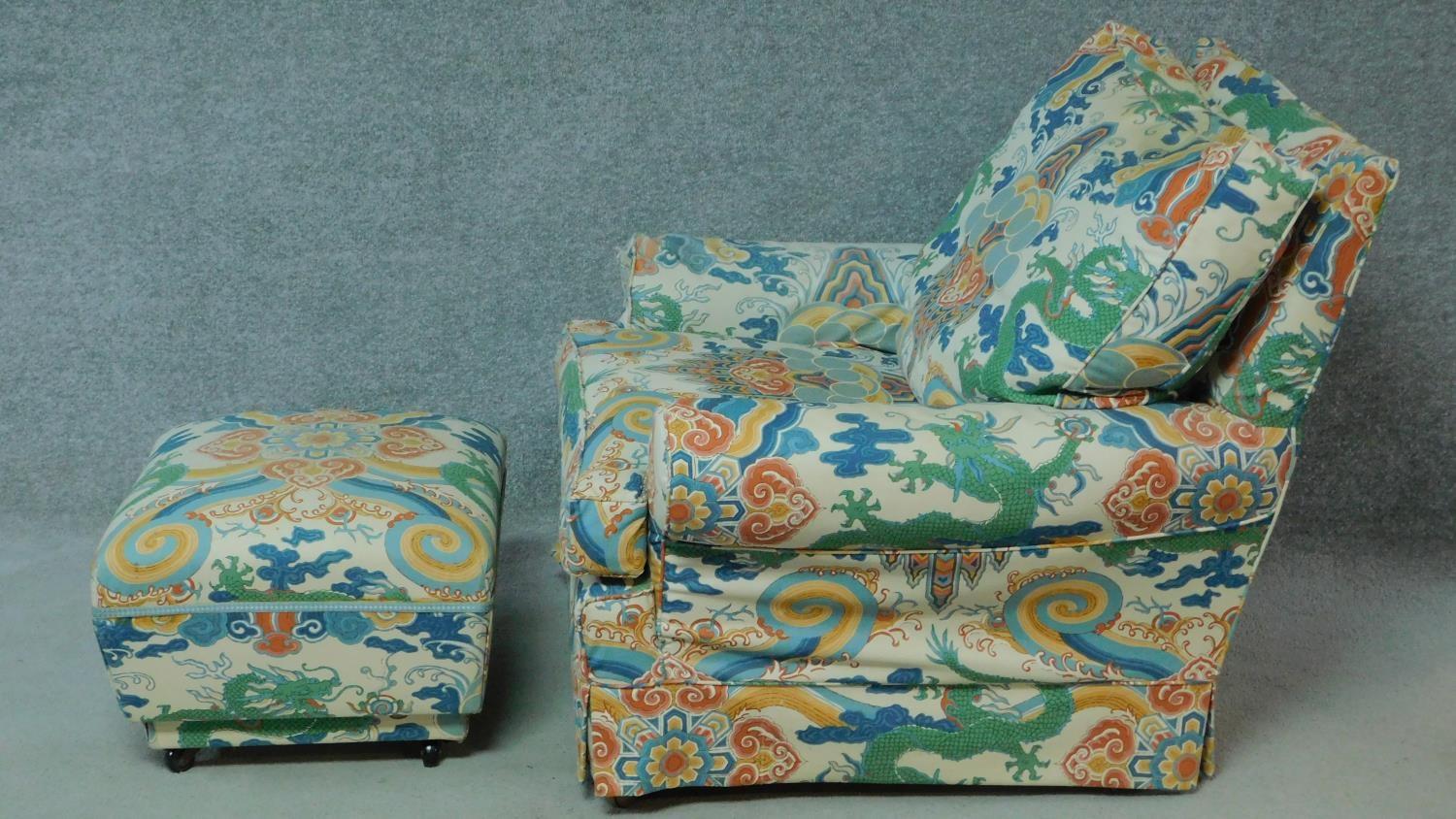 An armchair in polychrome Chinese style upholstery with the matching footstool. H.84cm