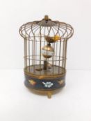 A vintage brass bird cage clock with floral cloisonne enamel decoration, two birds painted and