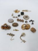 A collection of antique yellow metal and silver brooches. Including a blood stone and gold plated