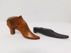 An antique treen wooden pin cushion in the form of a heeled boot, with tacks for buttons and