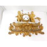 Parts of an antique French gilt bronze clock on a white alabaster base. It has a gilt ormolu bracket