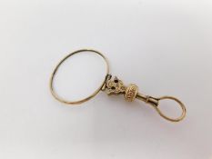 A 19th century yellow metal engraved single lorgnette. It has a faceted rim and floral engraving