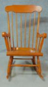 A 19th century style teak framed rocking chair. H.102cm
