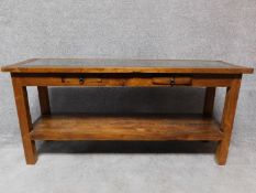 An Eastern hardwood console table with two frieze drawers on square supports united by undertier.