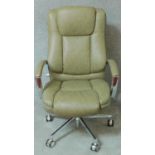 A contemporary chrome framed swivel armchair with lumbar support in sage green upholstery. H.110cm