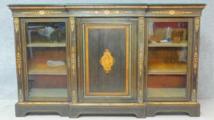 A late Victorian ebonised and satinwood inlaid credenza with ormolu mounts and central panel door