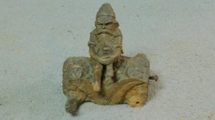 A 20th century Black Forest carved wooden stamp box and inkwell of a gnome sitting on a log. Half