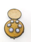 A cased set of Georgian opal foil glass and cut steel waistcoat buttons. A set of six in a green