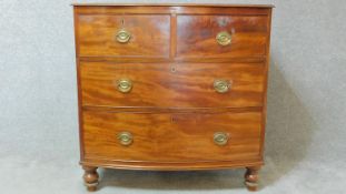 A Regency mahogany bowfronted chest of drawers on turned bun feet. H.92 W.93 D.56cm