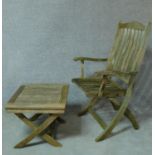A weathered teak folding garden chair and a matching table, makers label to underside. H.104cm
