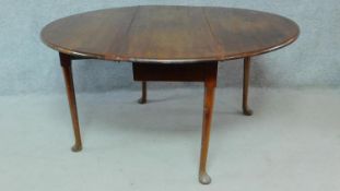 A Georgian mahogany drop flap gateleg dining table on four pad foot supports. H.70 W.139 D.123cm