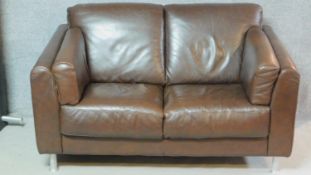 A contemporary two seater brown leather sofa. H.85 W.146 D.88cm