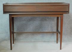 A mid century teak hall table fitted with frieze drawers on square tapering stretchered supports.