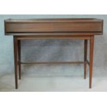 A mid century teak hall table fitted with frieze drawers on square tapering stretchered supports.