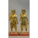 A pair of early 20th century South East Asian lacquered carved gilt wood statues of Oriental warrior