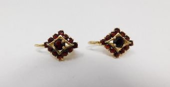A pair of vintage 18 carat yellow gold and garnet diamond shaped earrings. Each set with thirteen