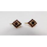 A pair of vintage 18 carat yellow gold and garnet diamond shaped earrings. Each set with thirteen