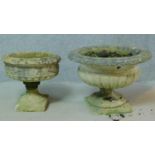 A reconstituted stone Regency style garden urn and another similar. H.47cm (damage to both).