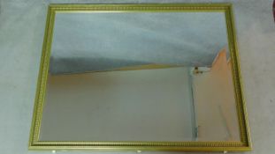 A large wall mirror in gilt and reeded frame.118x151cm