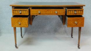 A late 19th century Sheraton style rosewood writing table with inset tooled leather top and