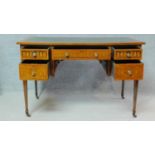 A late 19th century Sheraton style rosewood writing table with inset tooled leather top and