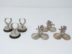Collection of antique silver and silver plate menu holders. A set of three stag head menu holders on
