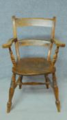 A 19th century country style open armchair with elm seat on turned stretchered supports. H.89cm