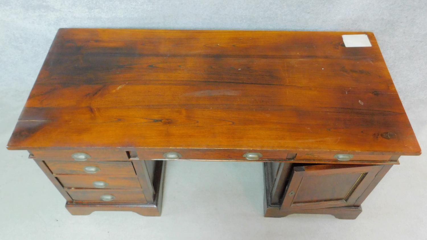 An Eastern teak three part pedestal desk fitted with a cupboard and drawers on bracket feet. H.78 - Image 3 of 5