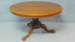 A Victorian mahogany tilt top dining table on tripod carved cabriole supports. H.68 W.122 D.122cm
