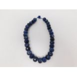 A honeycomb faceted Sodalite bead nacklace with Lapis Lazuli silk chord loop clasp. Comprised of