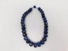 A honeycomb faceted Sodalite bead nacklace with Lapis Lazuli silk chord loop clasp. Comprised of