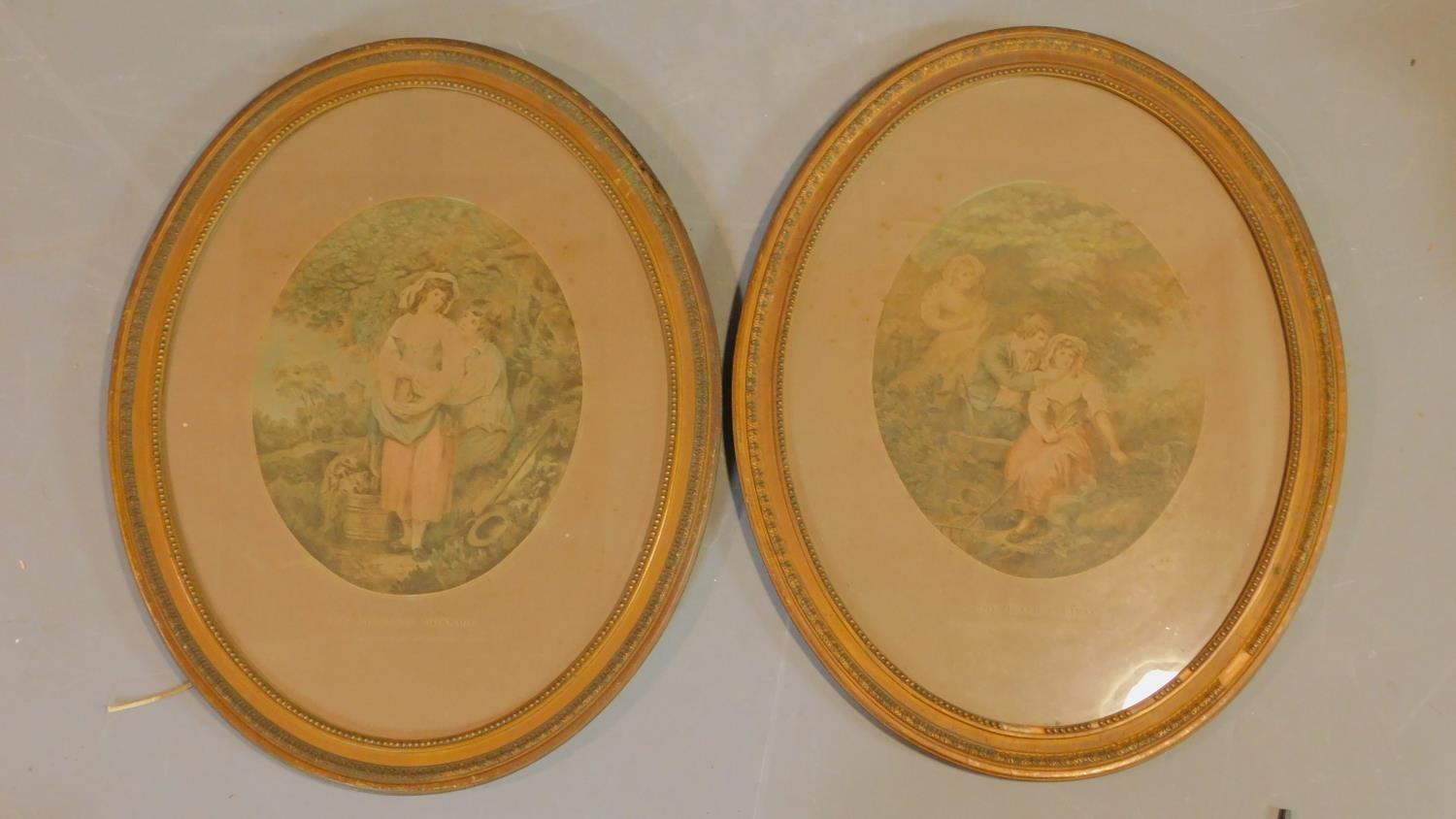 A pair of Victorian framed and glazed coloured lithographs on silk of couples. 57x47cm