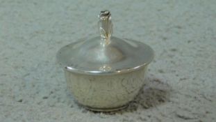 A miniature silver lidded sugar bowl and tongs by Tiffany & Co. with rose bud finial and miniature