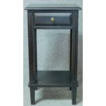 An Empire style painted lamp table with frieze drawer on square section supports united by