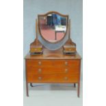 An Edwardian mahogany and satinwood strung dressing table fitted with central bevelled plate